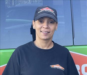 One of our Production Technicians, Mel, standing in front of one of our SERVPRO vehicles.