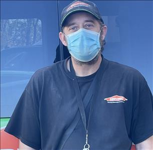Rick Schwenke, one of our Crew Chiefs, standing in front of one of our SERVPRO vehicles.