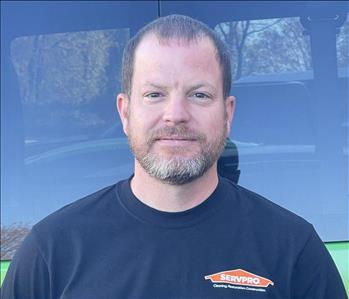 Tim Smith, our Construction Operations Manager, standing in front of one of our SERVPRO vehicles.