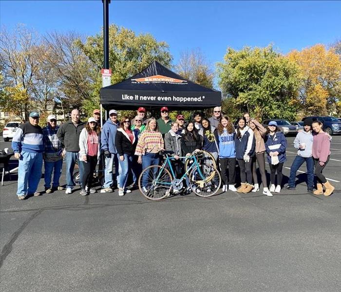 Newtown Rotary Club standing in front of SERVPROs tent at their even, Pedals for Progress