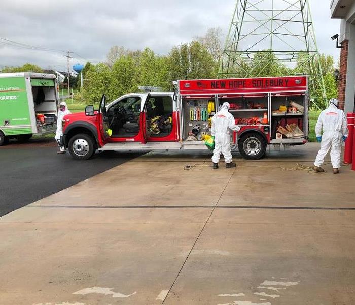 Technicians fogging fire truck